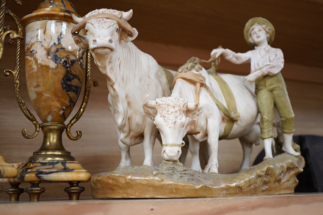 A large Royal Dux porcelain group of a pair oxen with a farm hand, pink triangle mark. 38cm wide
